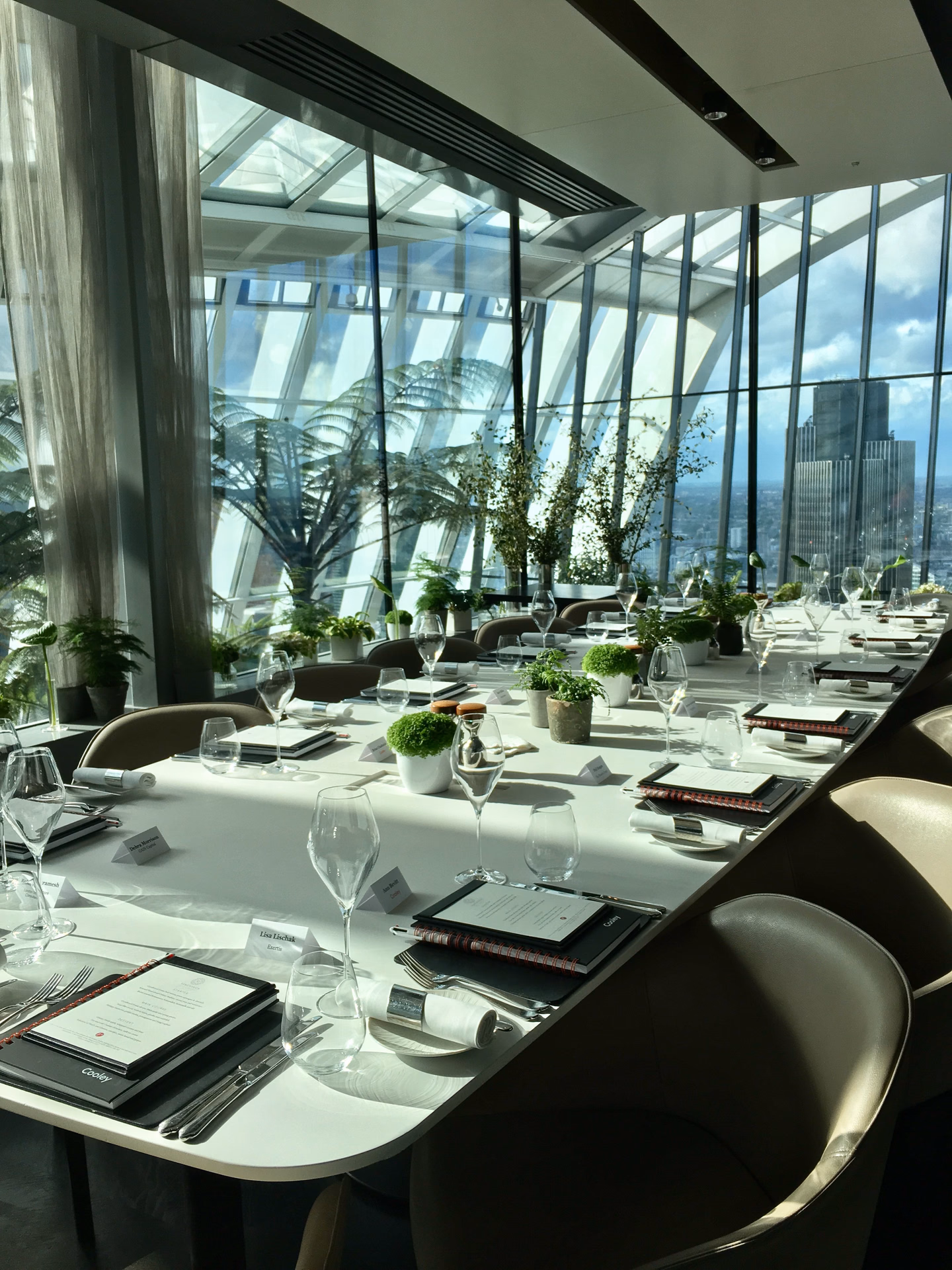 Modern luxury event pavilion with floor-to-ceiling glass panoramic views and timber architectural beams