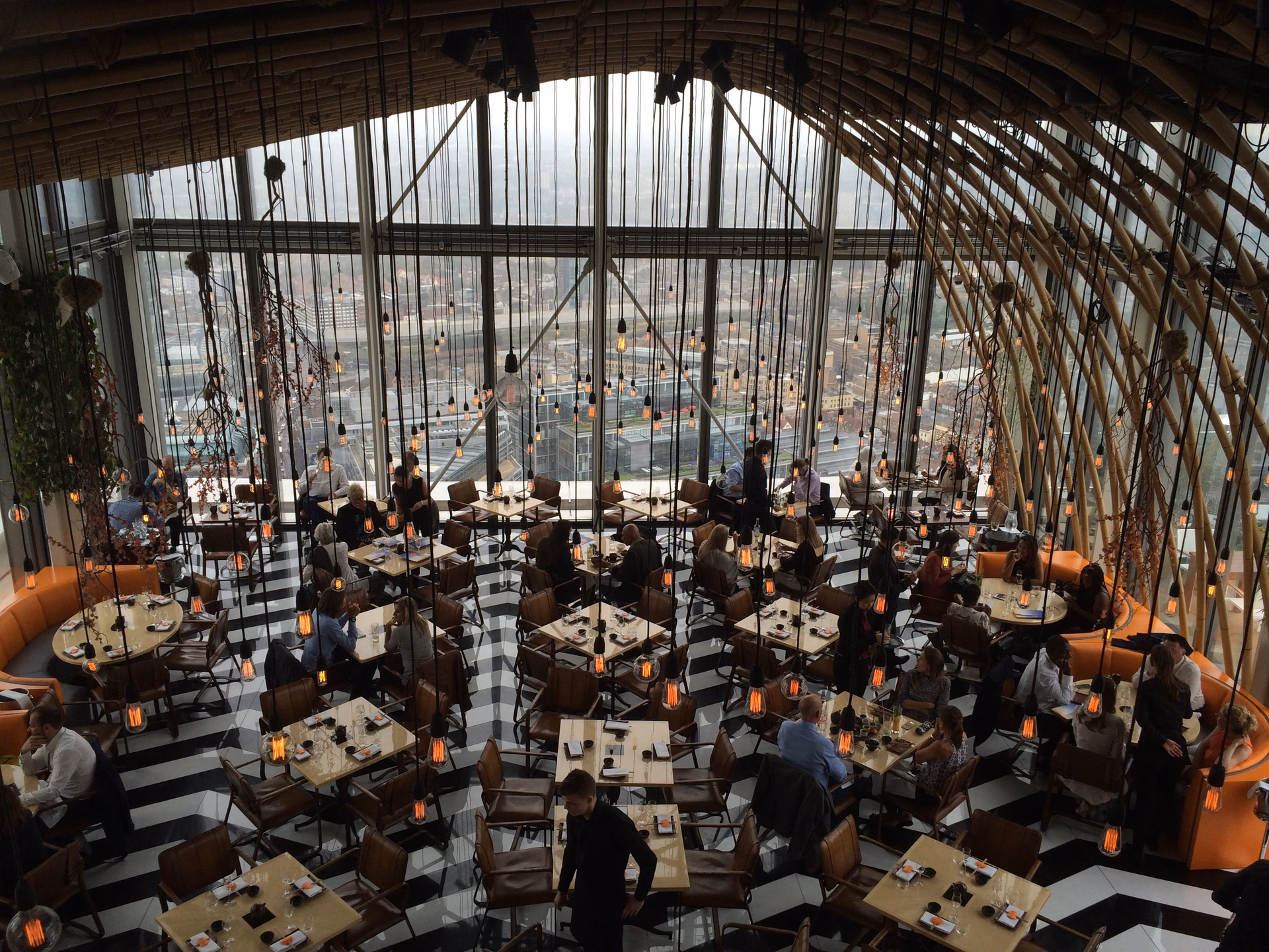Modern luxury event pavilion with floor-to-ceiling glass panoramic views and timber architectural beams