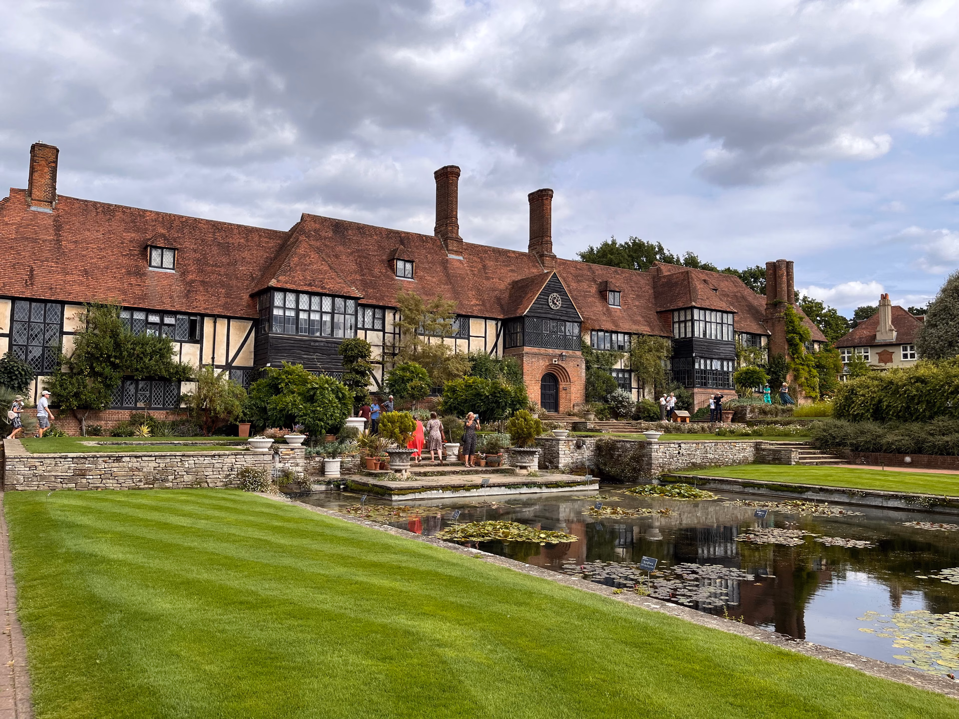Stately English country manor estate with manicured lawns and warm evening illumination in Surrey